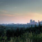 Downtown Edmonton at dusk above the forested North Saskatchewan River Valley